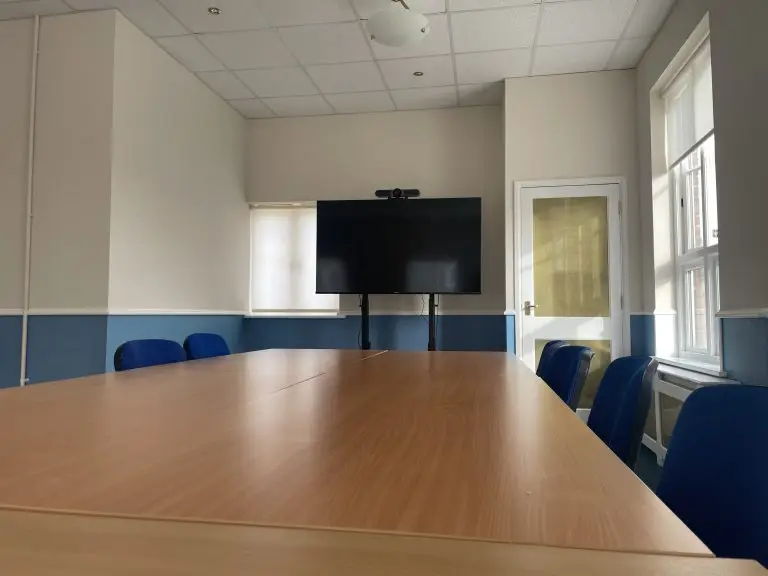 STARS Board Room showing table, chairs and a large screen
